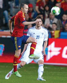Spain&rsquo;s Andres Iniesta (left) reaches the ball first ahead of Kasper Hamalainen, of Finland, at the Molinon stadium, Gijon.