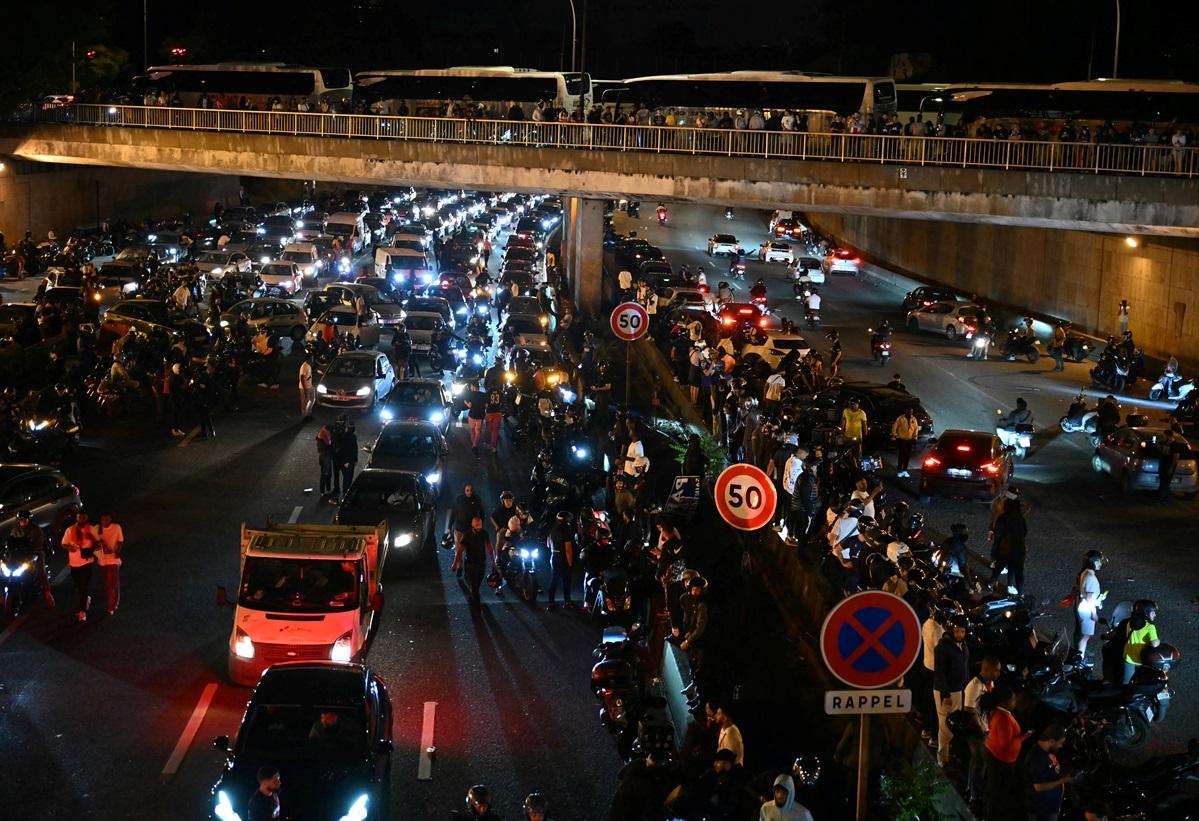 Paris Saint-Germain (PSG) supporters and motorists halt on the Peripherique between Porte Maillot and Porte Champerret in Paris.