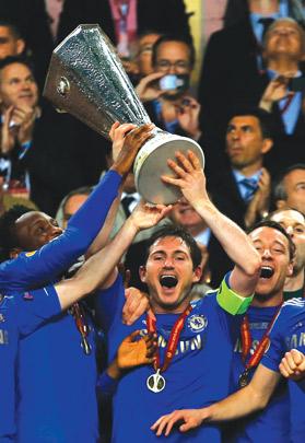 Chelsea captain Frank Lampard lifts the Europa League trophy at the Amsterdam Arena last night. A stoppage-time goal from Branislav Ivanovic helped Chelsea become the first English club to win all three of UEFA's major trophies as they beat Benfica 2-1. Photo: Eddie Keogh Reuters