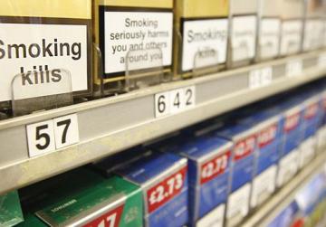 how old do you need to be to buy cigarettes A sign with the legal age to purchase cigarettes and tobacco products  stands behind the counter of a retail store in New York City on April 23,  2013. New York City Mayor