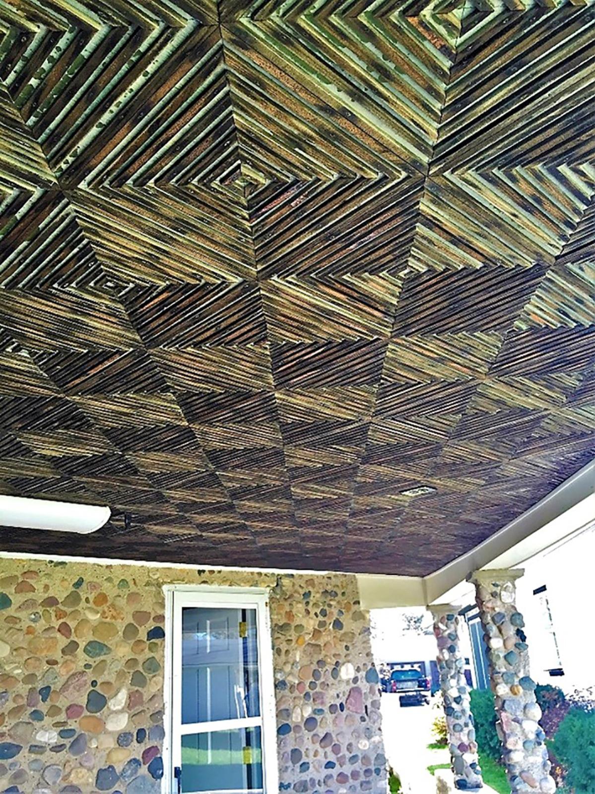 The ceiling of the porch decorated with strips from old orange crates.