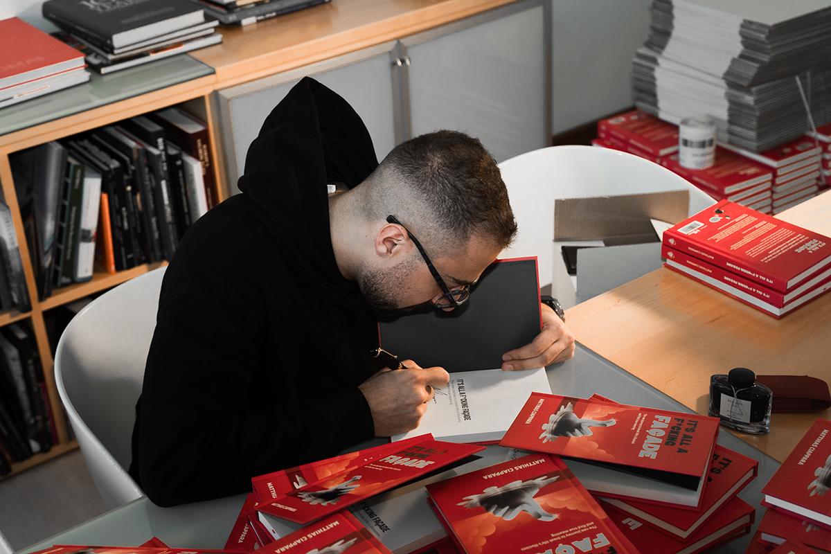 Matthias Ciappara signing copies of his book.