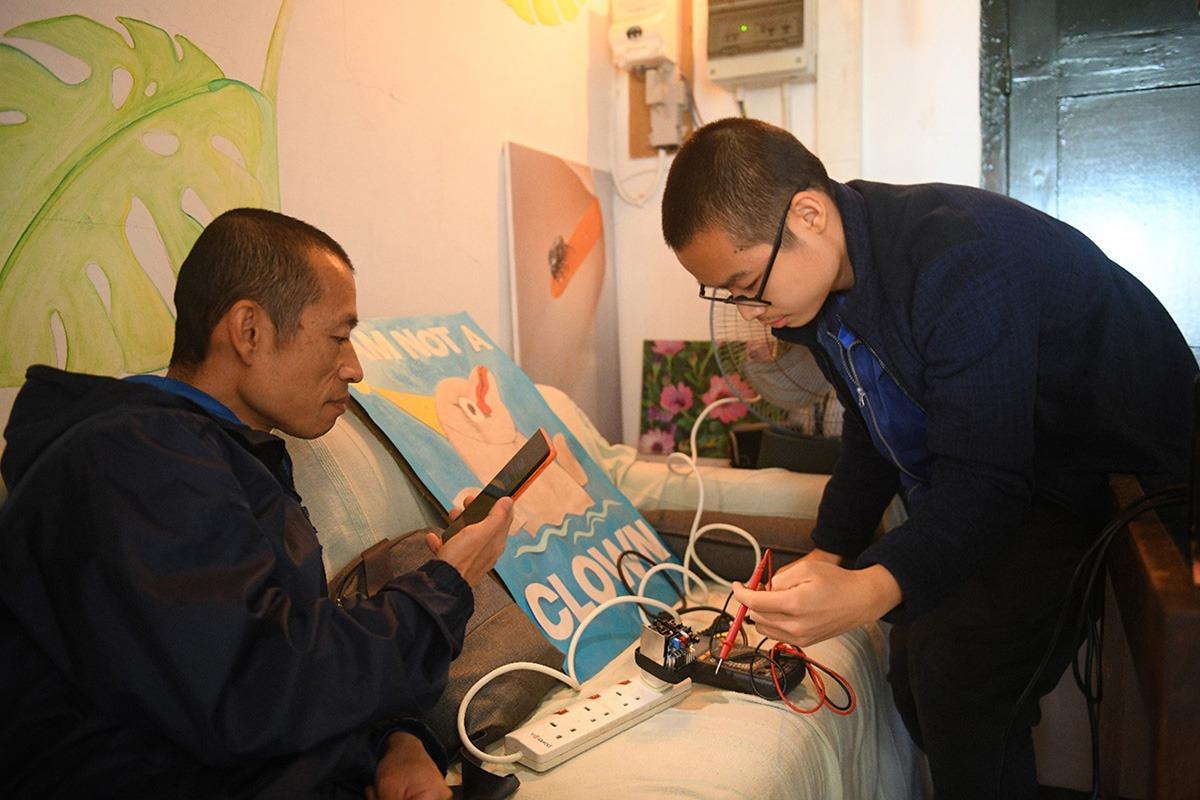 People working on fixing some electronics.