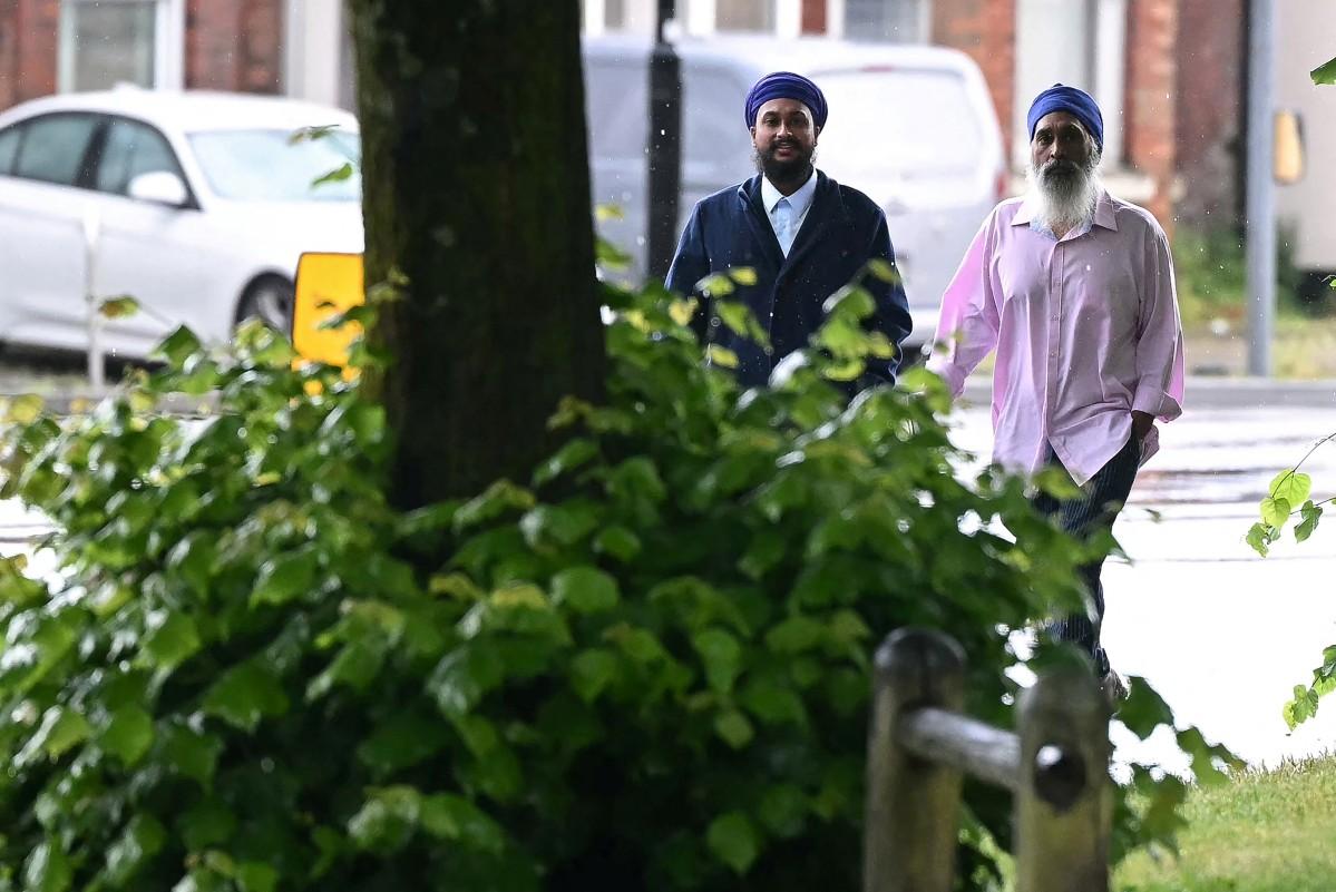 Moga Singh (R), the father of Vickrum Digwa who was found guilty of killing Henry Nowak, and Vickrum's brother Gurpreet Digwa (L) arrive at the Courts of Justice to face charges of possession of offensive weapons. Photo: AFP