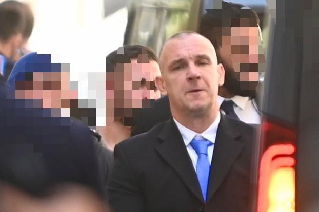 Dragomanski accompanied by police officers during an onsite visit to the crime scene. Photo: Jonathan Borg
