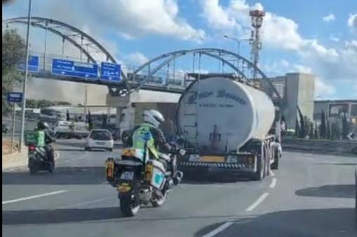 LESA officials escort a bowser of water through traffic.