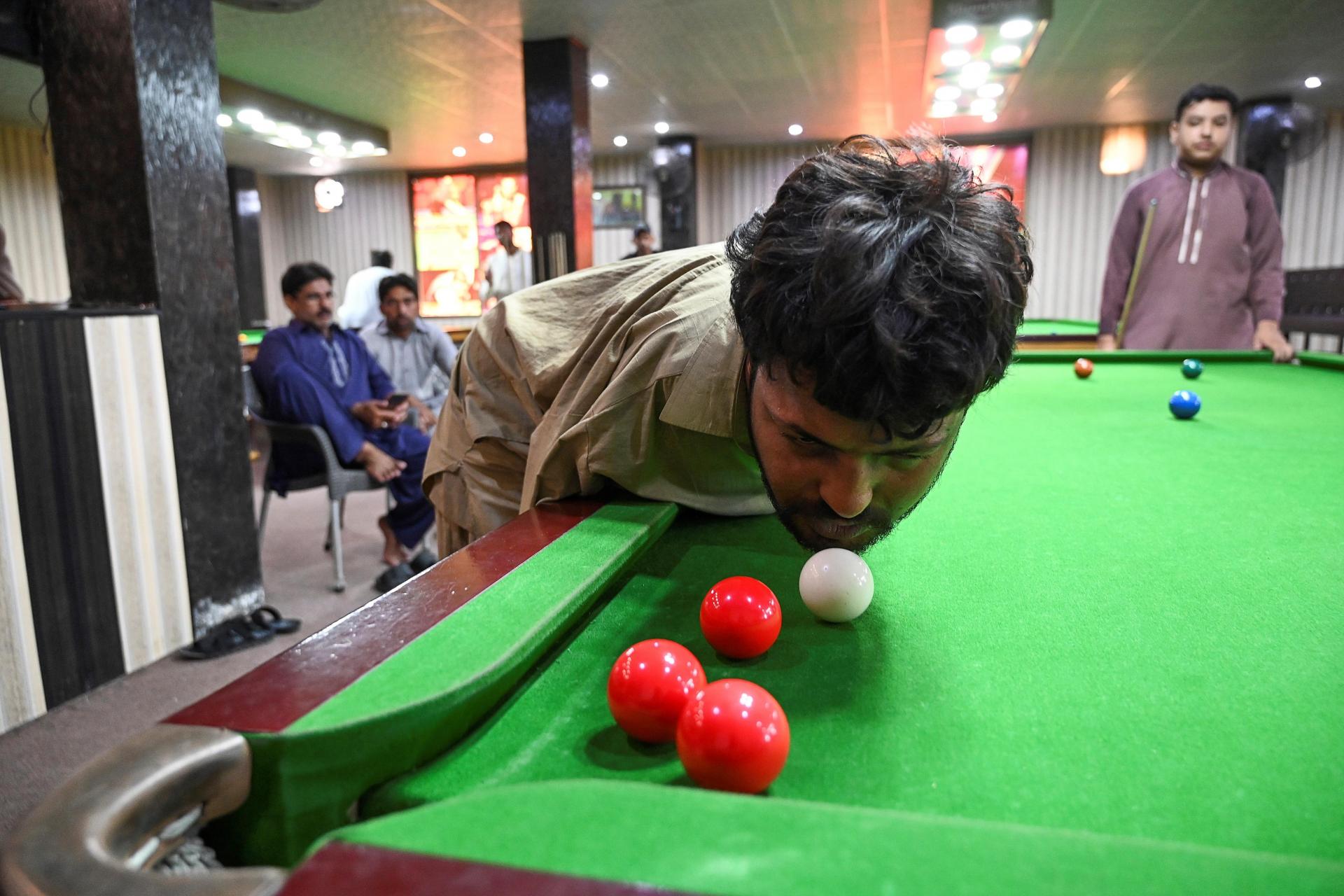 Muhammad Ikram plays a shot with his chin. Photo: AFP