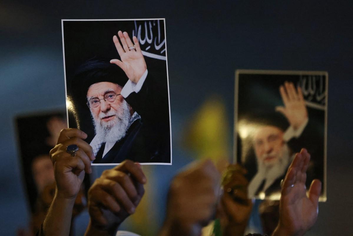Iraqi Shia clerics hold portraits of Iran's slain supreme leader Ayatollah Ali Khamenei during a protest against the attacks by Israel and the US on Iran, as they march towards the US embassy in Baghdad on March 5