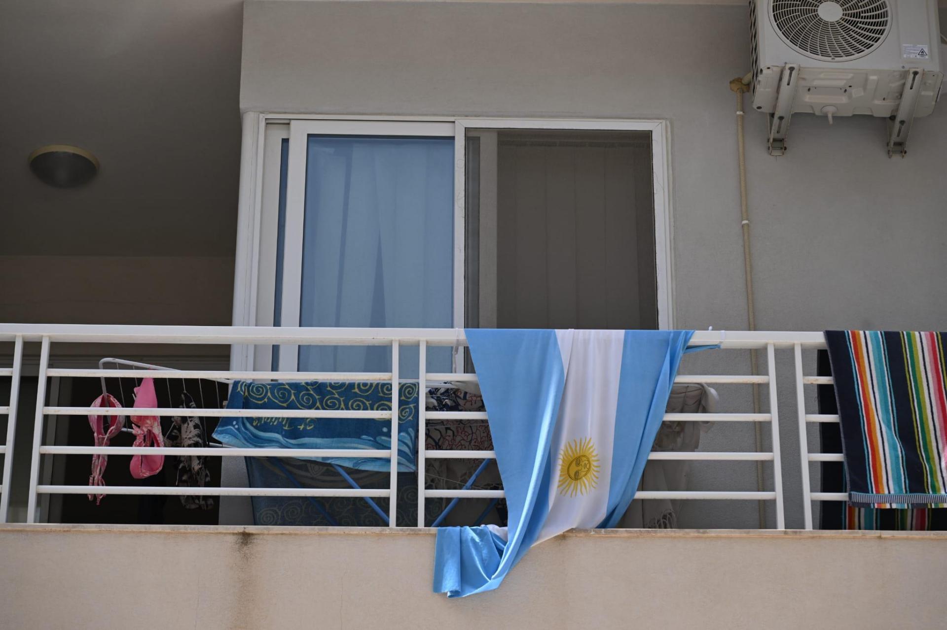 An Argentina flag flies amid the laundry. Photo: Matthew Mirabelli