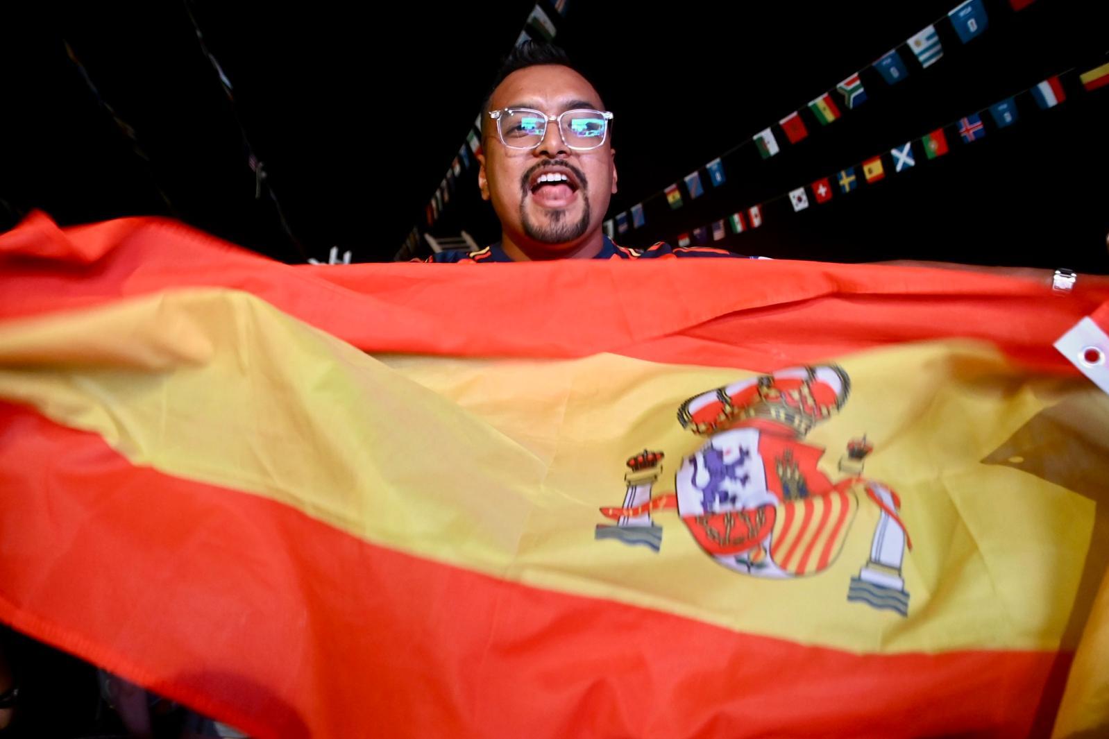 A Spanish fan waving their flag and jumping with joy after Spain won the World Cup Photo: Jonathan Borg