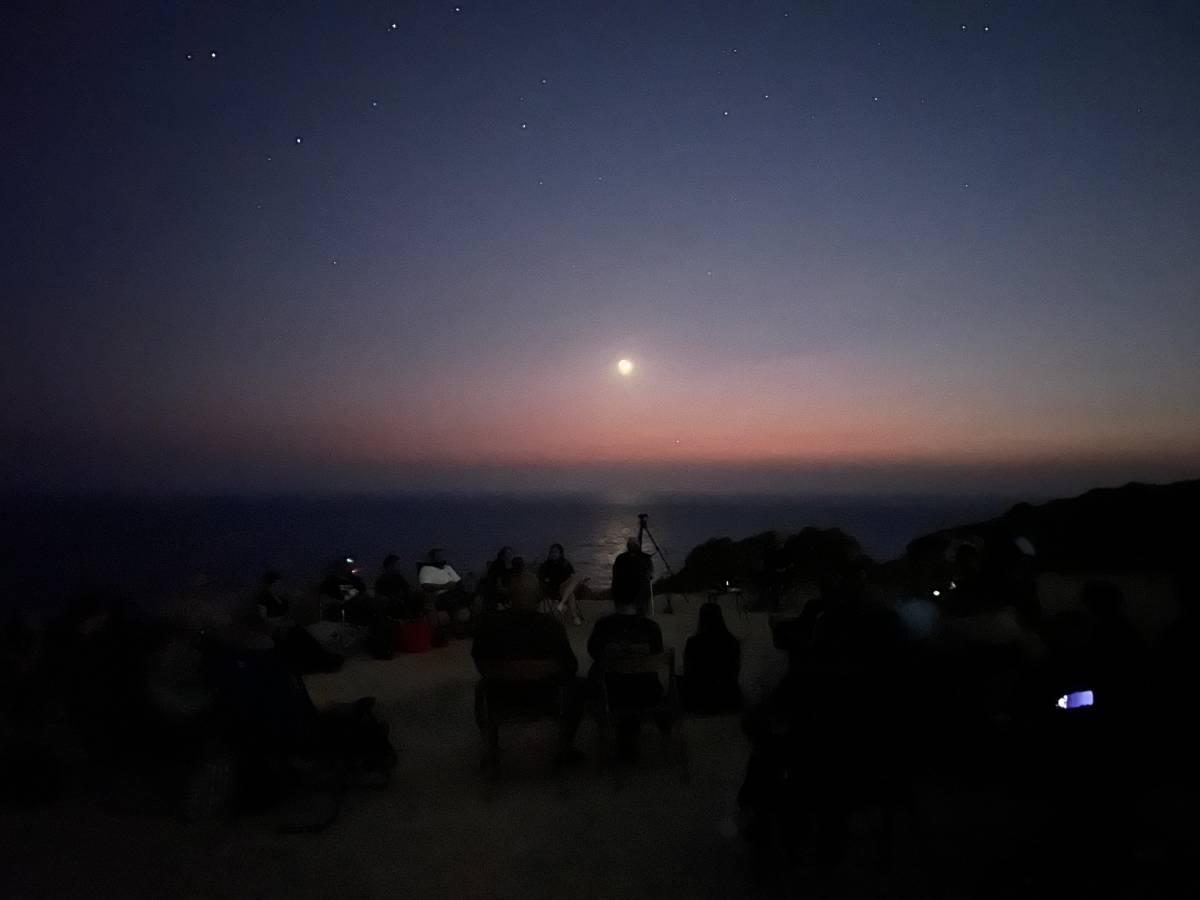 The group sits down in a circle to begin the CE-5 meditation.