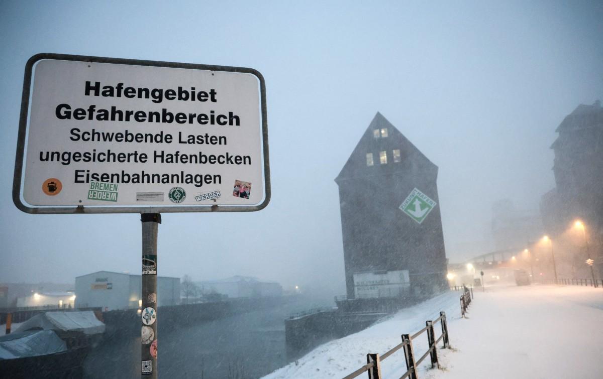 Warehouses are pictured in the port during heavy snowfall in Bremen, Germany. Photo: AFP