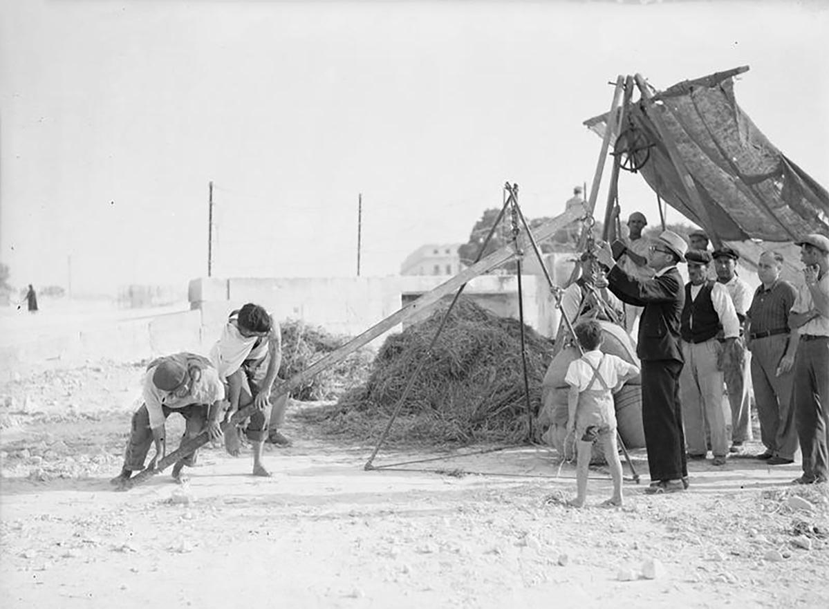 Bags of grain being weighed on August 17, 1942. Photo: Imperial War Museums