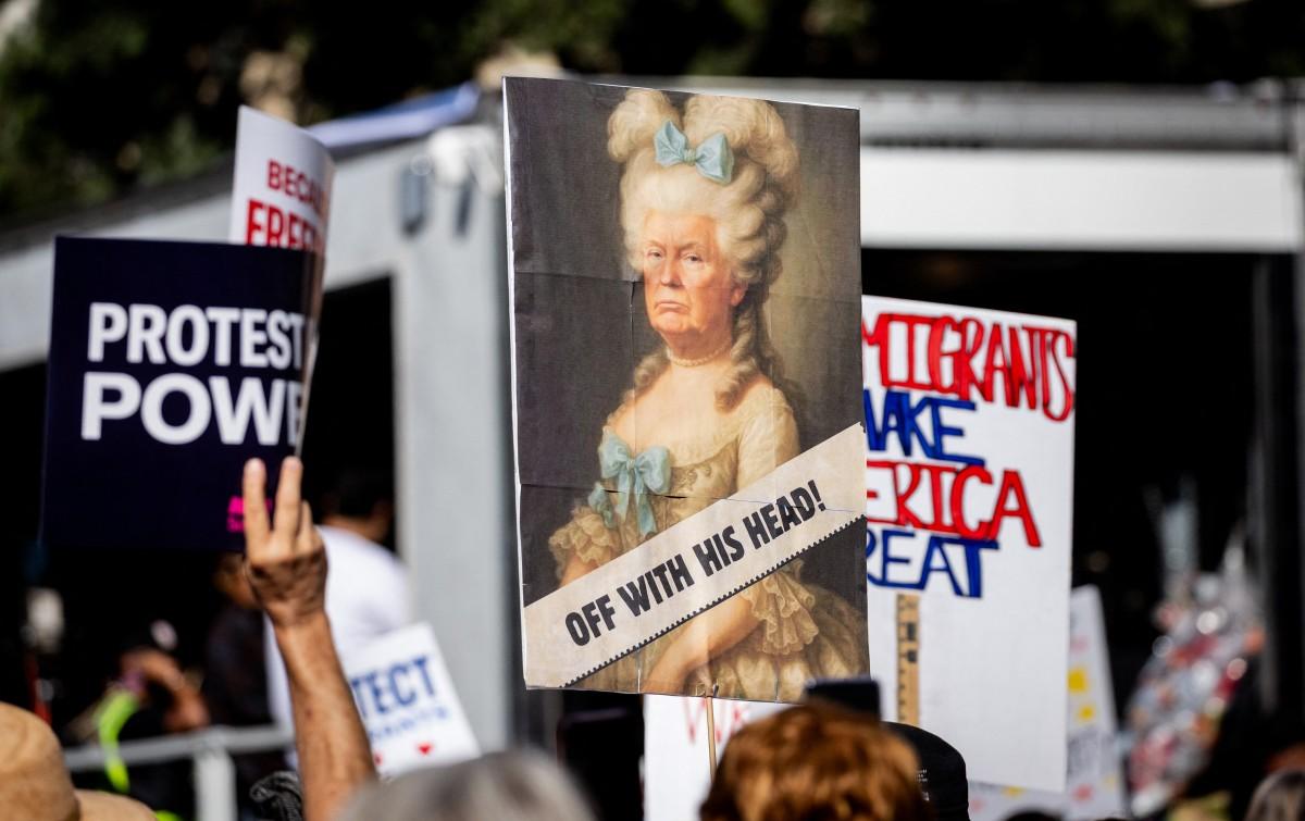 A parody poster featuring US President Donald Trump dressed as Marie Antoinette and the words "Off With Their Head". Photo: AFP