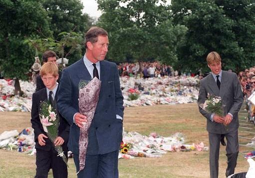 File: The Prince of Wales and his sons, Prince William (right) and Prince Harry, collect floral tributes to their mother, Diana, Princess of Wales, from the crowd at Kensington Palace, the former London residence of the princess. Photo: Rececca Naden / pool / AFP