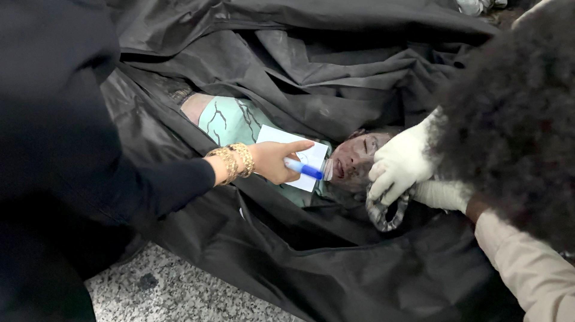 A handout picture released by the Iranian Press Center shows of the body of a little girl reportedly killed in a missile strike on a girl's school in Minab, Hormozgan Province, southeastern Iran. Photo: AFP