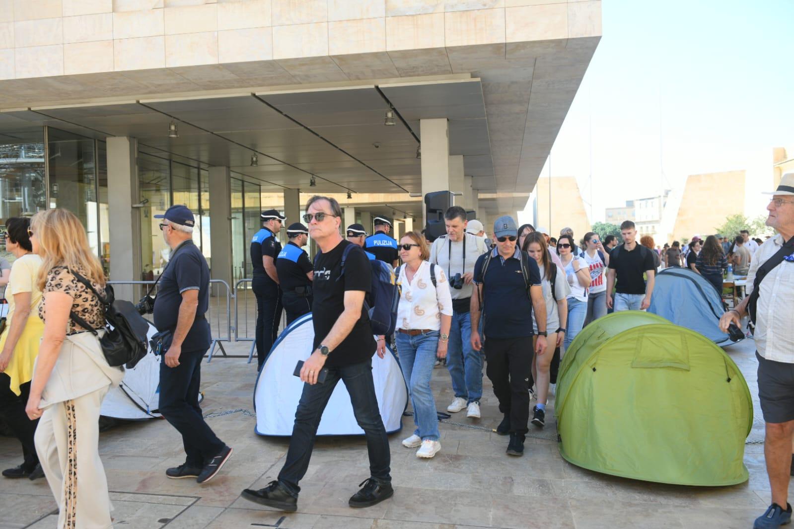 Tourists walking through the crowd of activists. Photo: Matthew Mirabelli