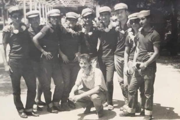 A group of men with crowns around their necks.