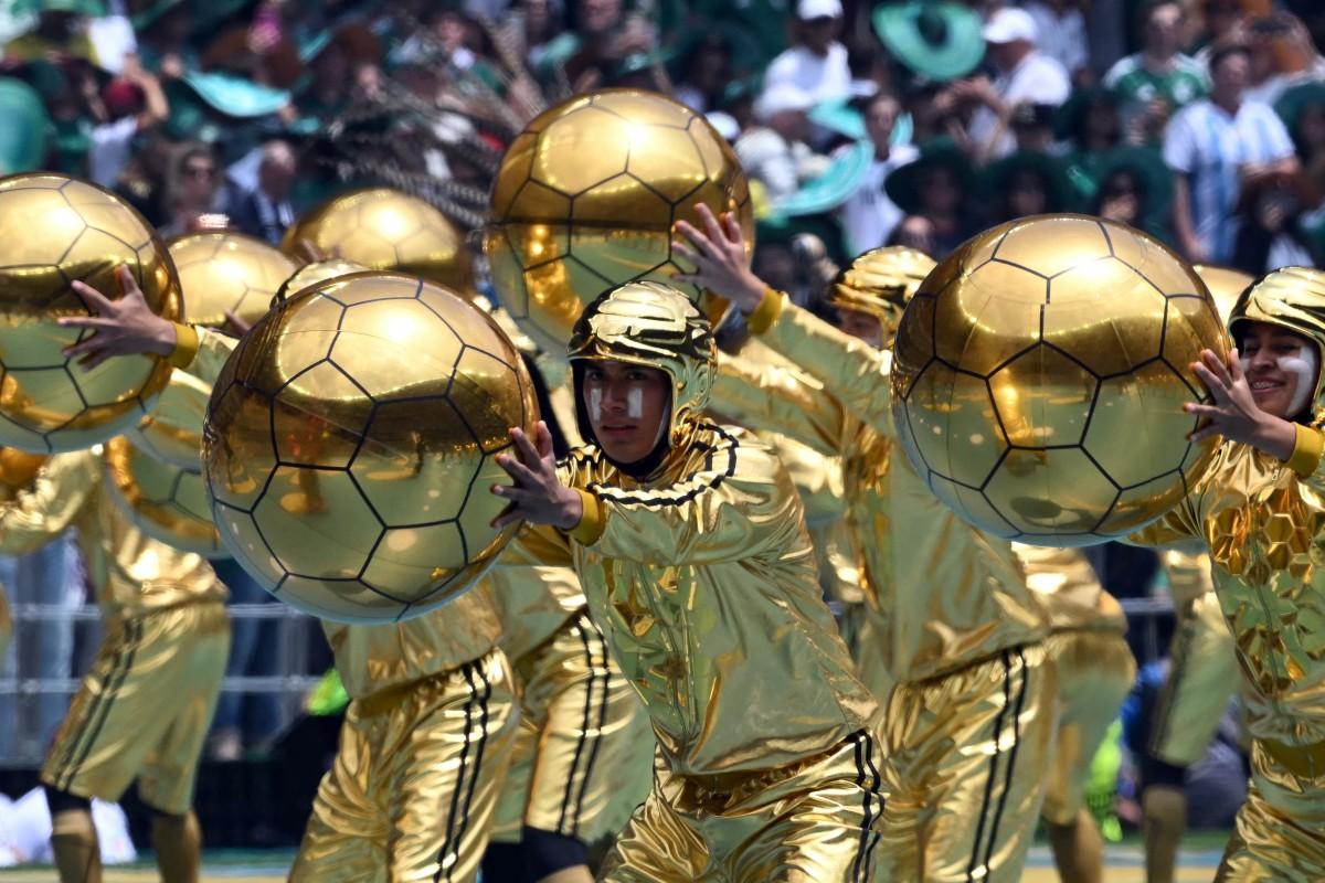 Golden balls and dancers light up with stadium in Mexico City as the opening ceremony gets underway. Photo: AFP