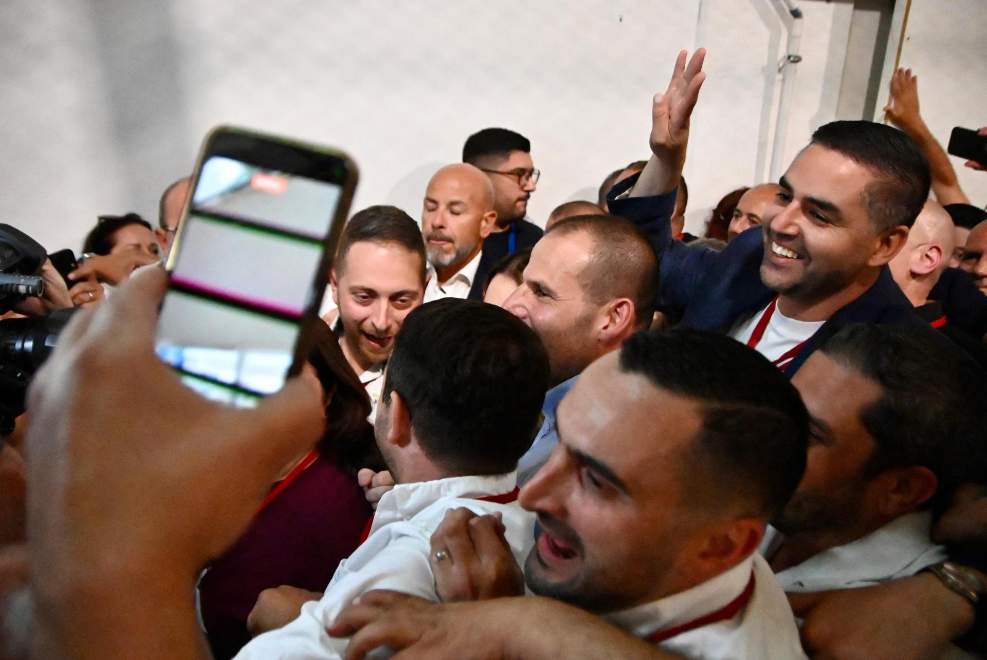 Robert Abela flanked by his two deputy leaders in a cramped Naxxar counting hall. Photo: Matthew Mirabelli