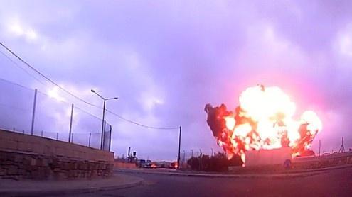 The plane catching fire after it crashed.