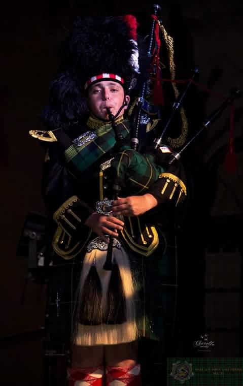 A young Saliba playing the bapipes with Wallace Pipes and Drums.