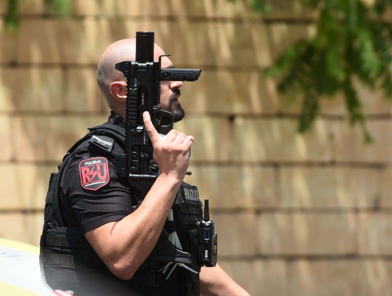 Officers with firearms converge on the site. Photo: Chris Sant Fournier