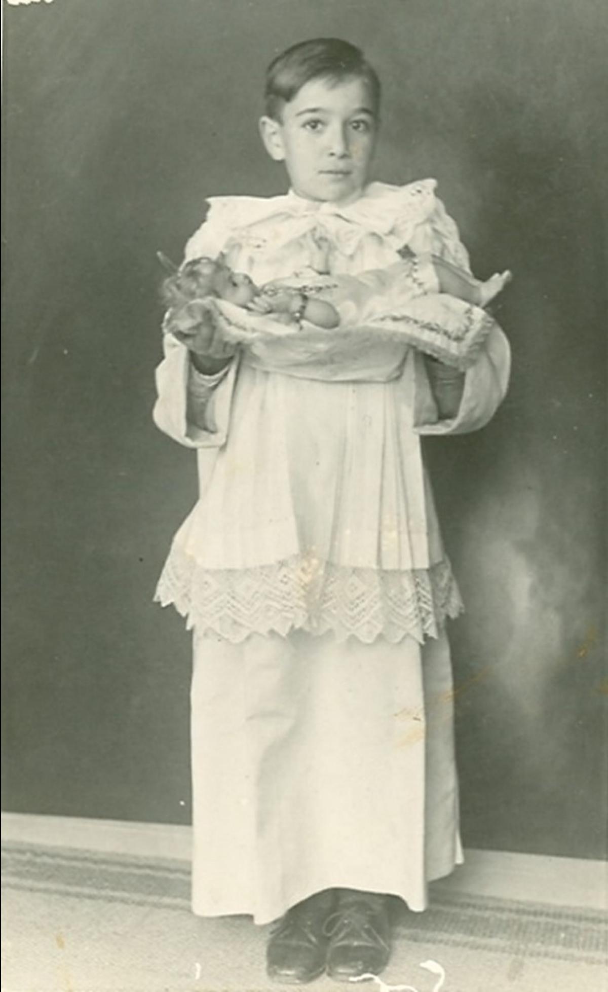 Francis Gatt holding the church&rsquo;s Baby Jesus statue after the Christmas midnight mass at Jesus of Nazareth parish church, Sliema, in 1935.