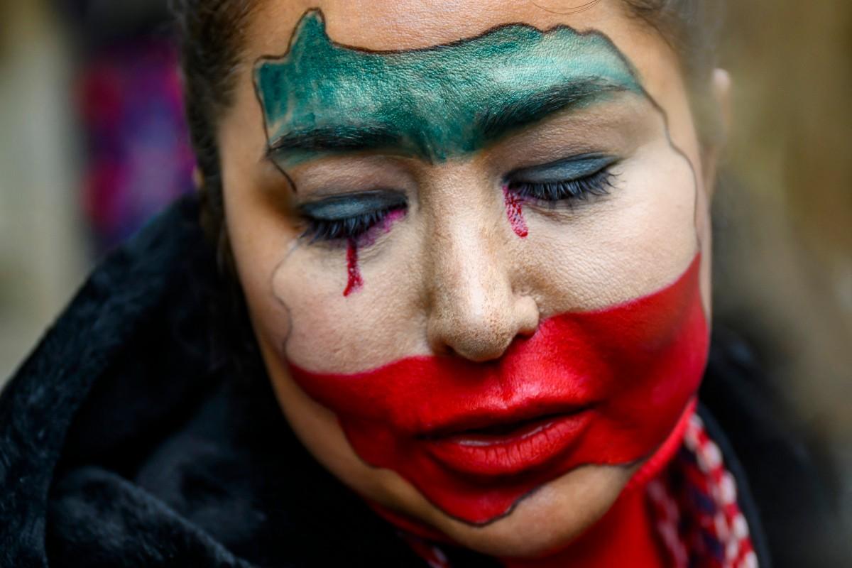 An anti-Iranian regime protester with her face painted in the colours of the Iranian flag takes part in a demonstration outside the Iranian Consulate, in Istanbul, on Sunday. Photo: AFP