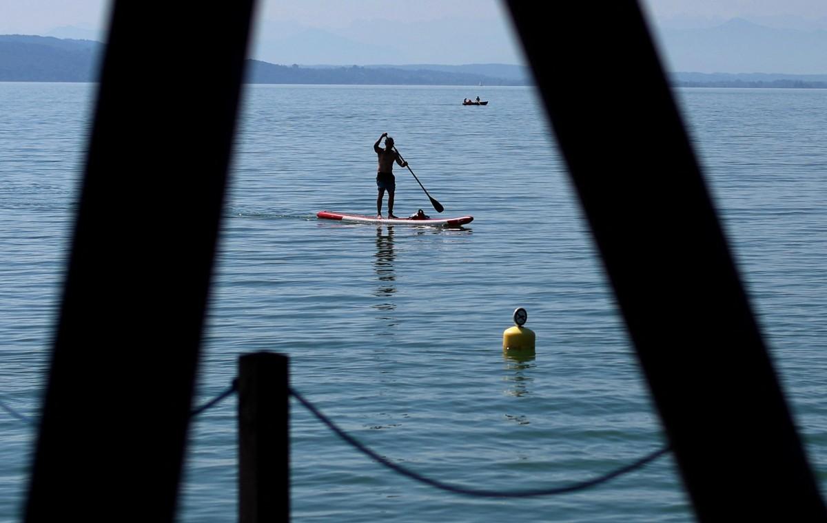 A stand-up paddleboarder paddles at Lake Ammersee in Utting, Germany. AFP