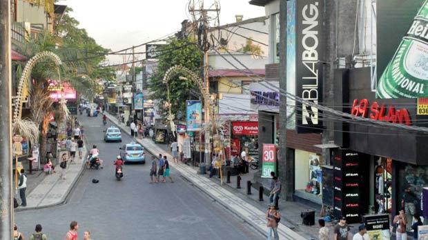 Legian Street in Kuta where high street shops meet bars and traffic.