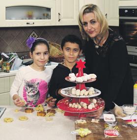 Lea Hogg cooking with her children in the kitchen. Lea Hogg cooking with her children in the kitchen.