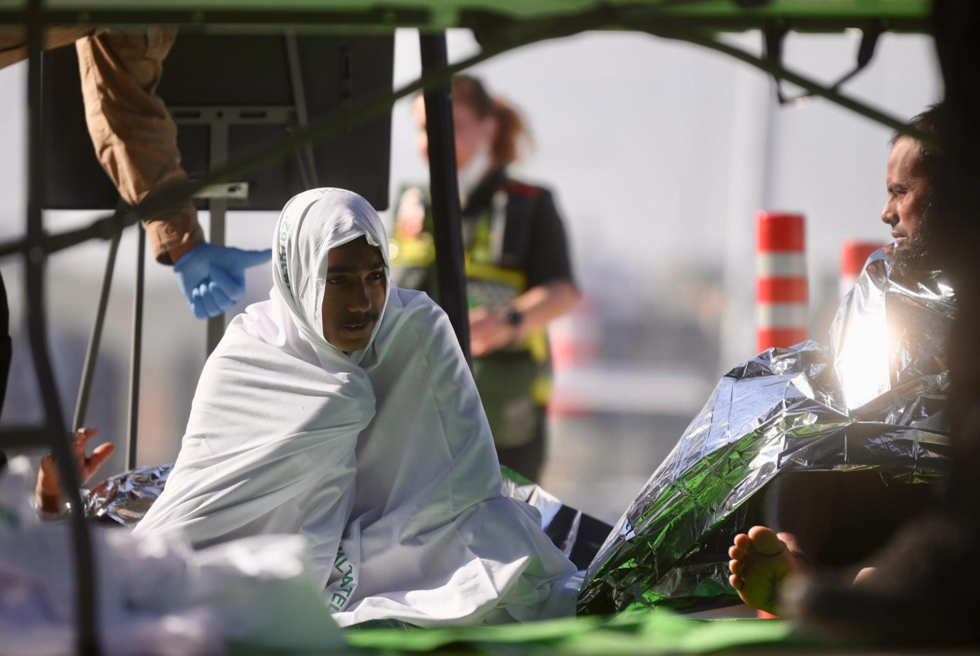 A man wrapped in a blanket, recovering from his ordeal. Photo: Jonathan Borg.