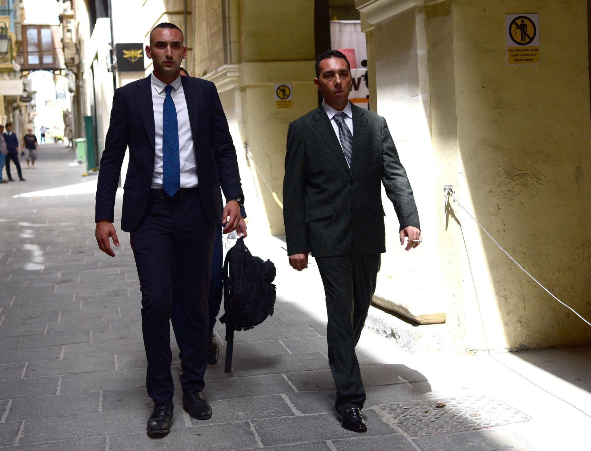 Melvin Theuma (right) being escorted to court in a previous sitting.