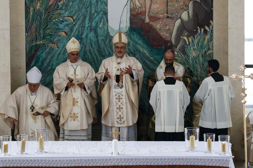 Pierbattista Pizzaballa (centre), the Latin Patriarch of Jerusalem, leads a mass at the Church of the Baptism of Christ.