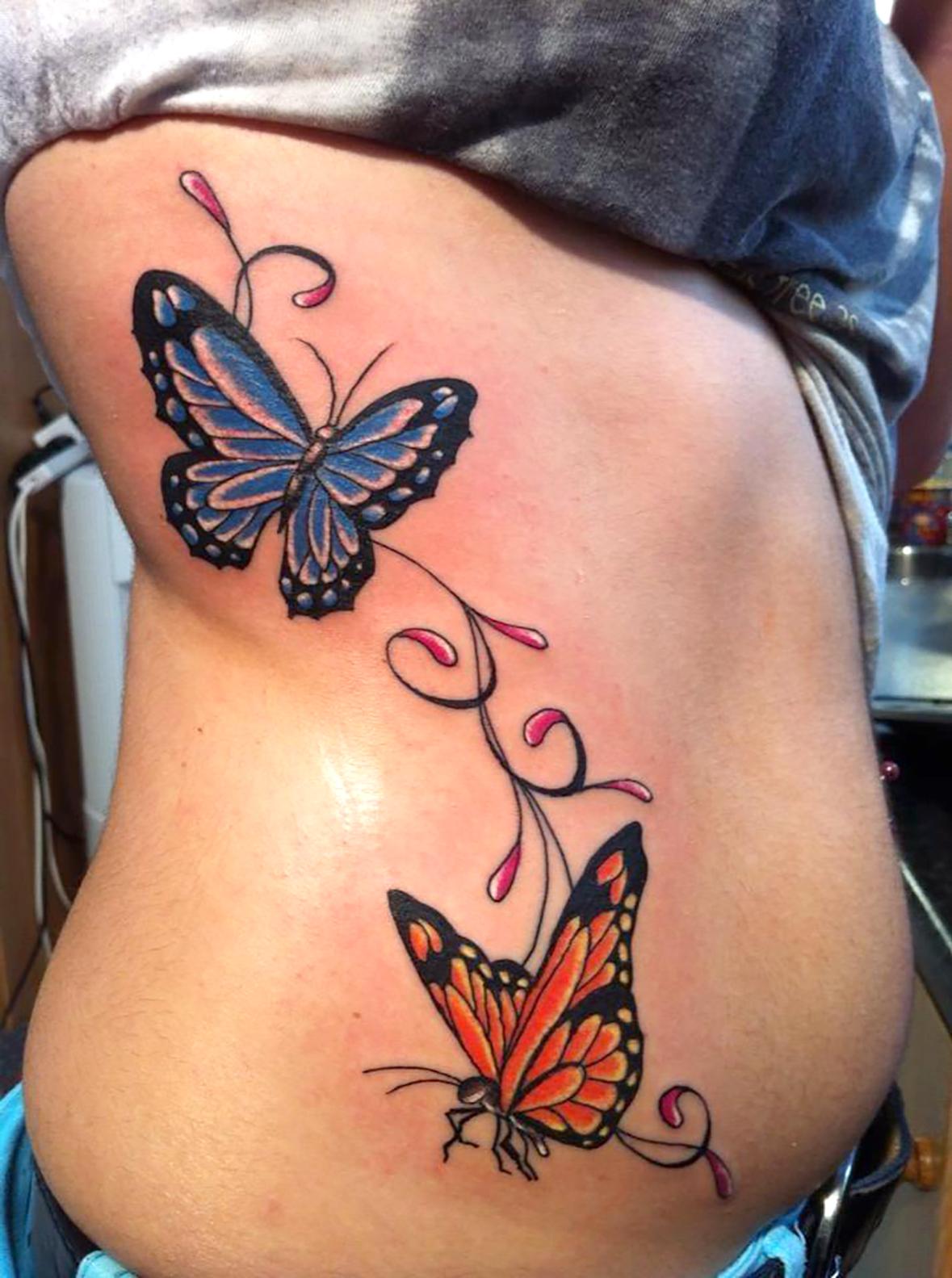 Butterflies on the ribcage, a painful location to ink. Photo: Isaac Wood