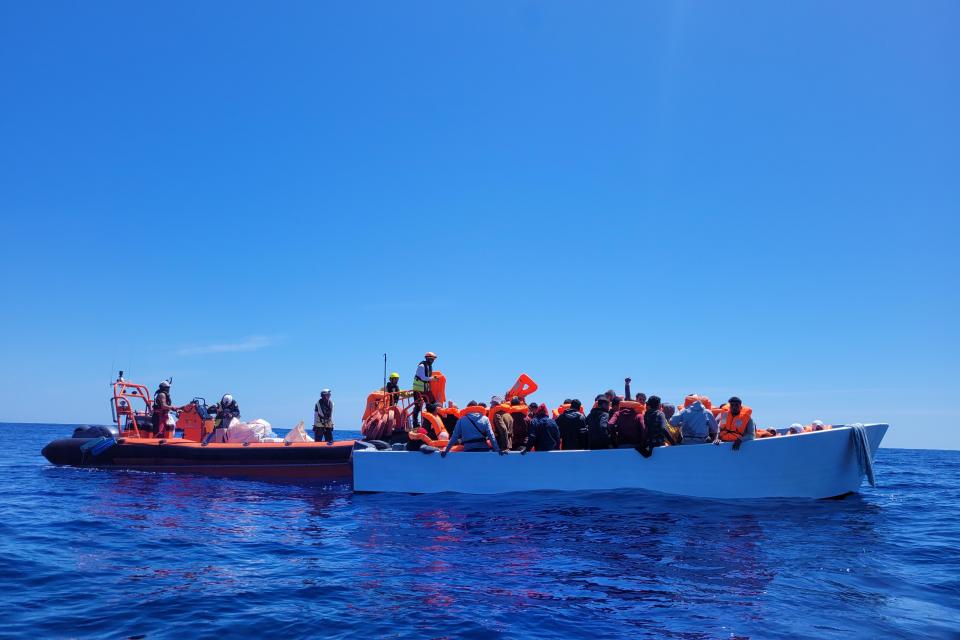 Rescuers reach one of the boats carrying migrants across the Mediterranean. Photo: SOS Mediterranee