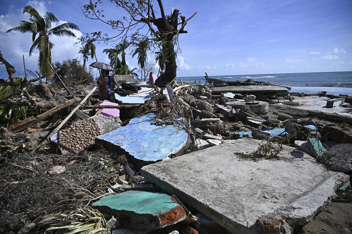 A couple walks amid debris of a damaged house after the passage of Hurricane Melissa in Boca de Dos Rios village, Santiago de Cuba province, Cuba. Photo: AFP
