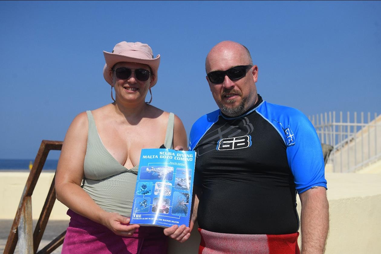 Divers Christina Woodcock and Chris Jiggens with Peter Lemon&rsquo;s book. Photo: Matthew Mirabelli