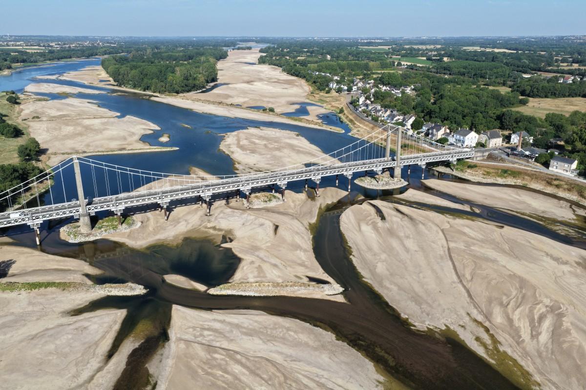 This aerial photograph shows a bridge over the dried out Loire River bed in Loireauxence (Varades), western France. Photo: AFP