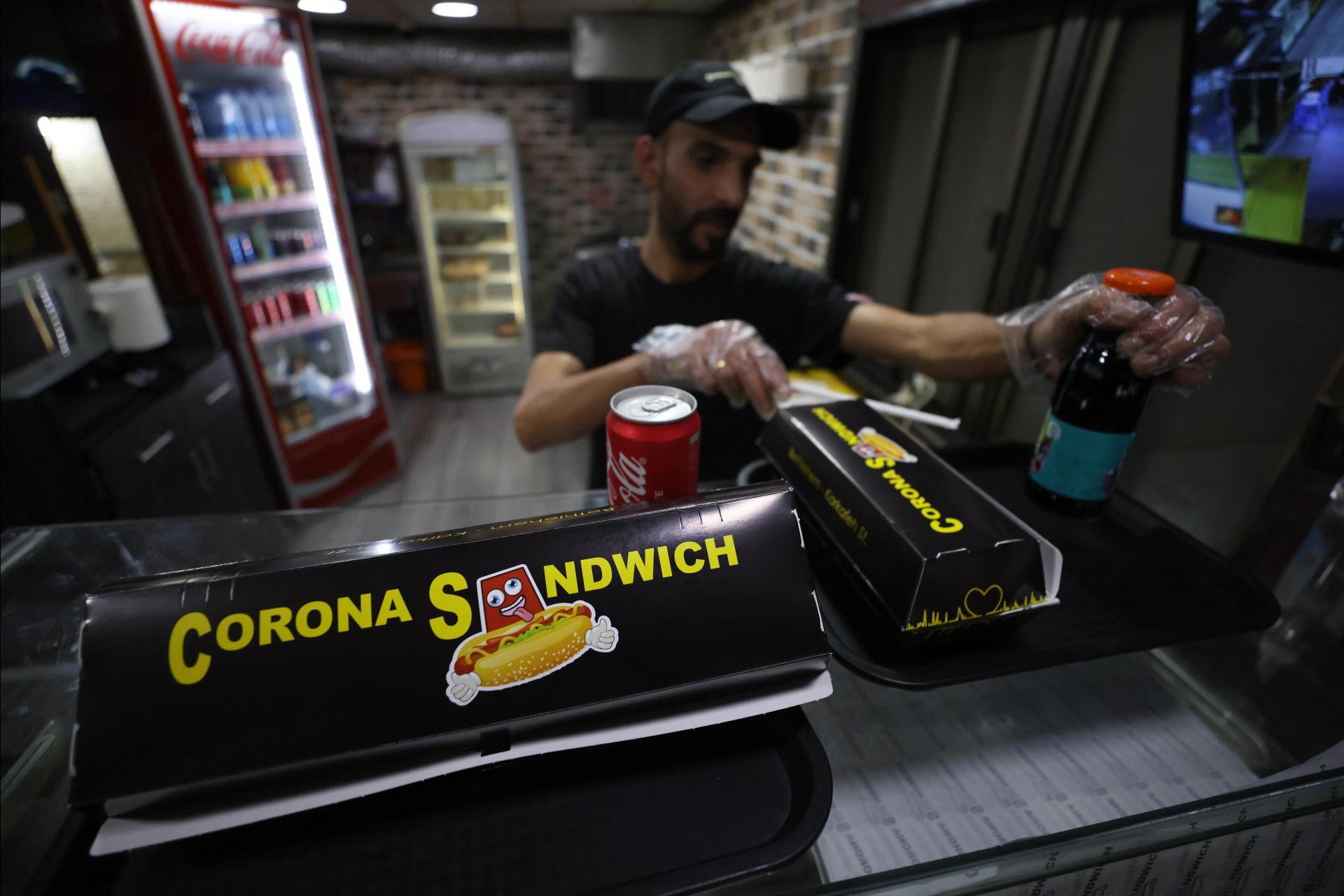 An employee of the &lsquo;Corona Sandwich&rsquo; restaurant prepares an order on November 6, 2020.