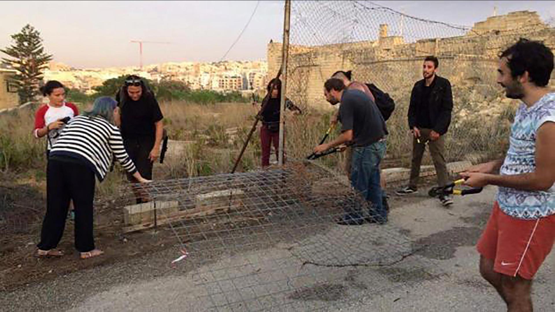 Activists bringing down fences in 2016.