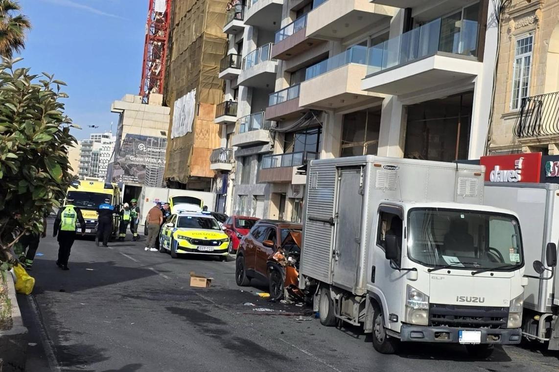 The delivery driver was trapped between the car and his truck. Photo: Times of Malta