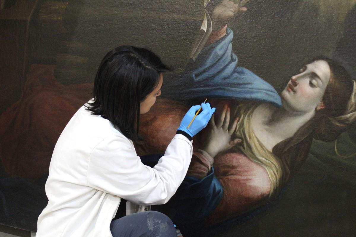 Conservation director Amy Sciberras carrying out the final retouching on the Annunciation altarpiece. Photo: ASC Conservation Centre Ltd