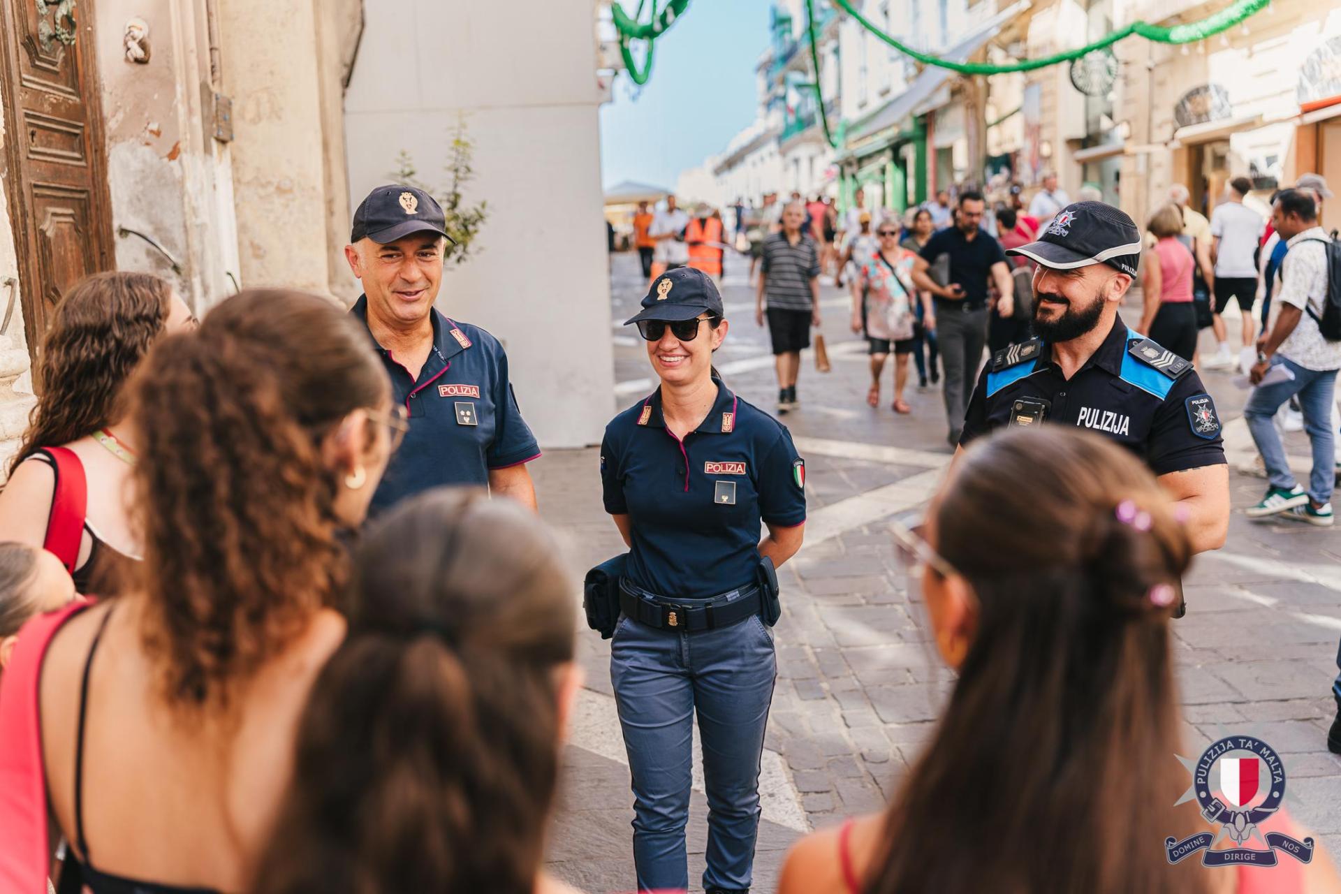 Ciao! A joint patrol of Maltese and Italian police officers meets Italian tourists in Republic Street.