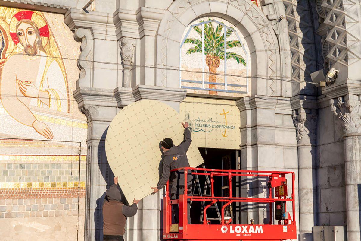 Workers begin to cover the mosaics at basilica of Our Lady of the Rosary in Lourdes. Photo: Lourdes Sanctuary