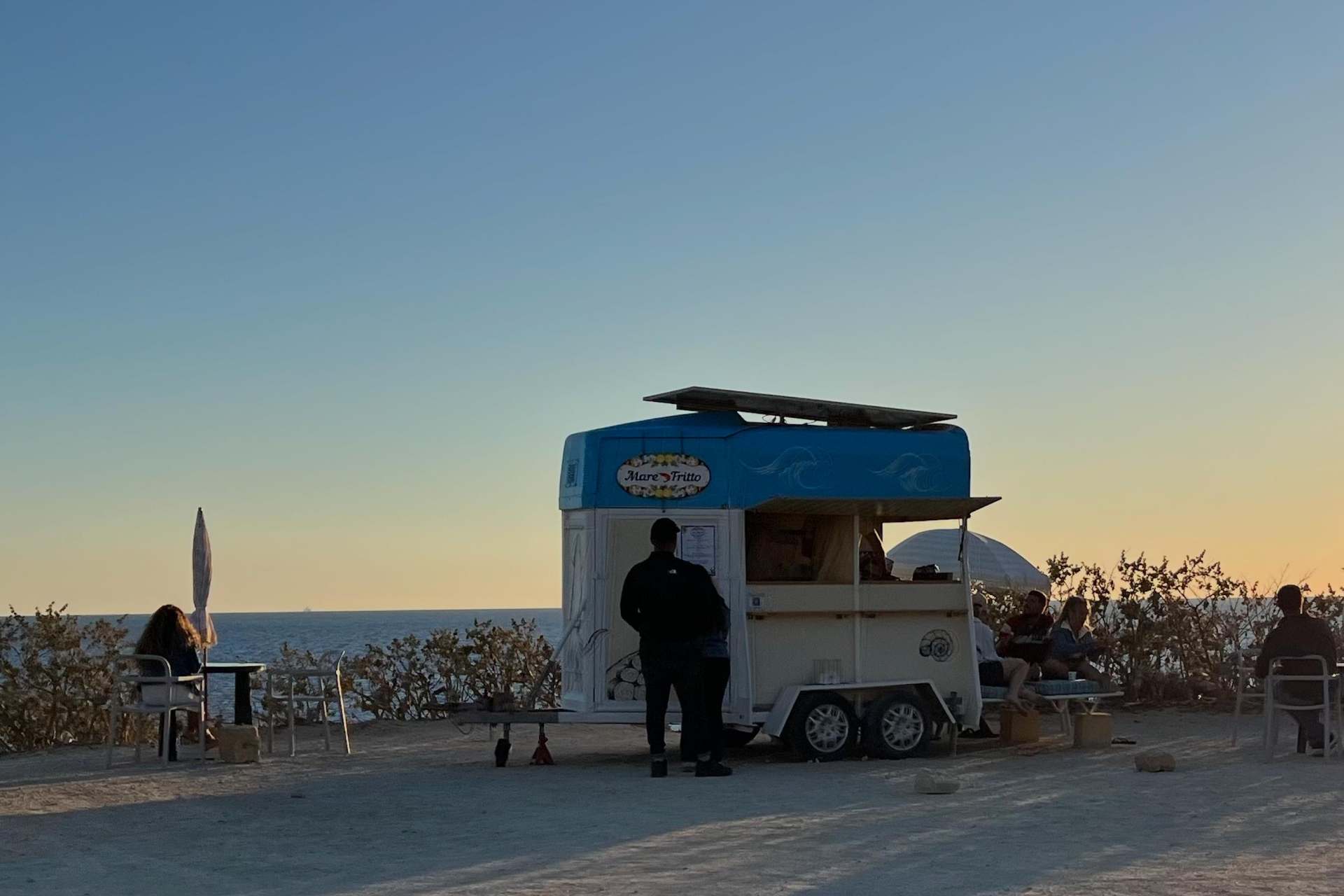 Kiosk seen set up in a public open space located across Fungus Rock with tables and chairs placed on the surrounding land. Photo: Din l-Art Ħelwa and the Coalition for Gozo