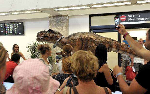 The Arrivals Lounge of the Malta International Airport welcomed Dino, an actor wearing an animatronic dinosaur suit on July 26. The dinosaur is part of a promotional campaign for a new game by online gaming company Pragmatic Play. Photo: Chris Sant Fournier