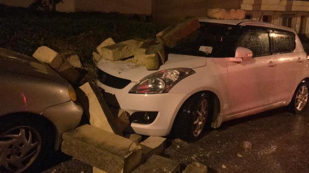 Cars damaged by a falling wall in Baħar iċ-Ċagħaq.