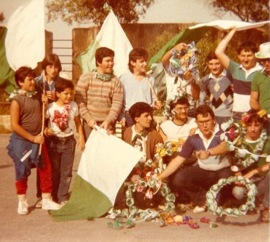 Men and boys carrying crowns and flags in the Floriana colours.